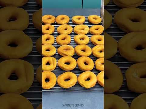 Perfectly glazed chocolate donuts on a grill tray 🍩